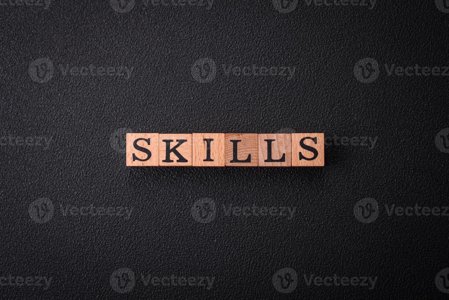 The inscription Skills made of wooden cubes on a plain background photo