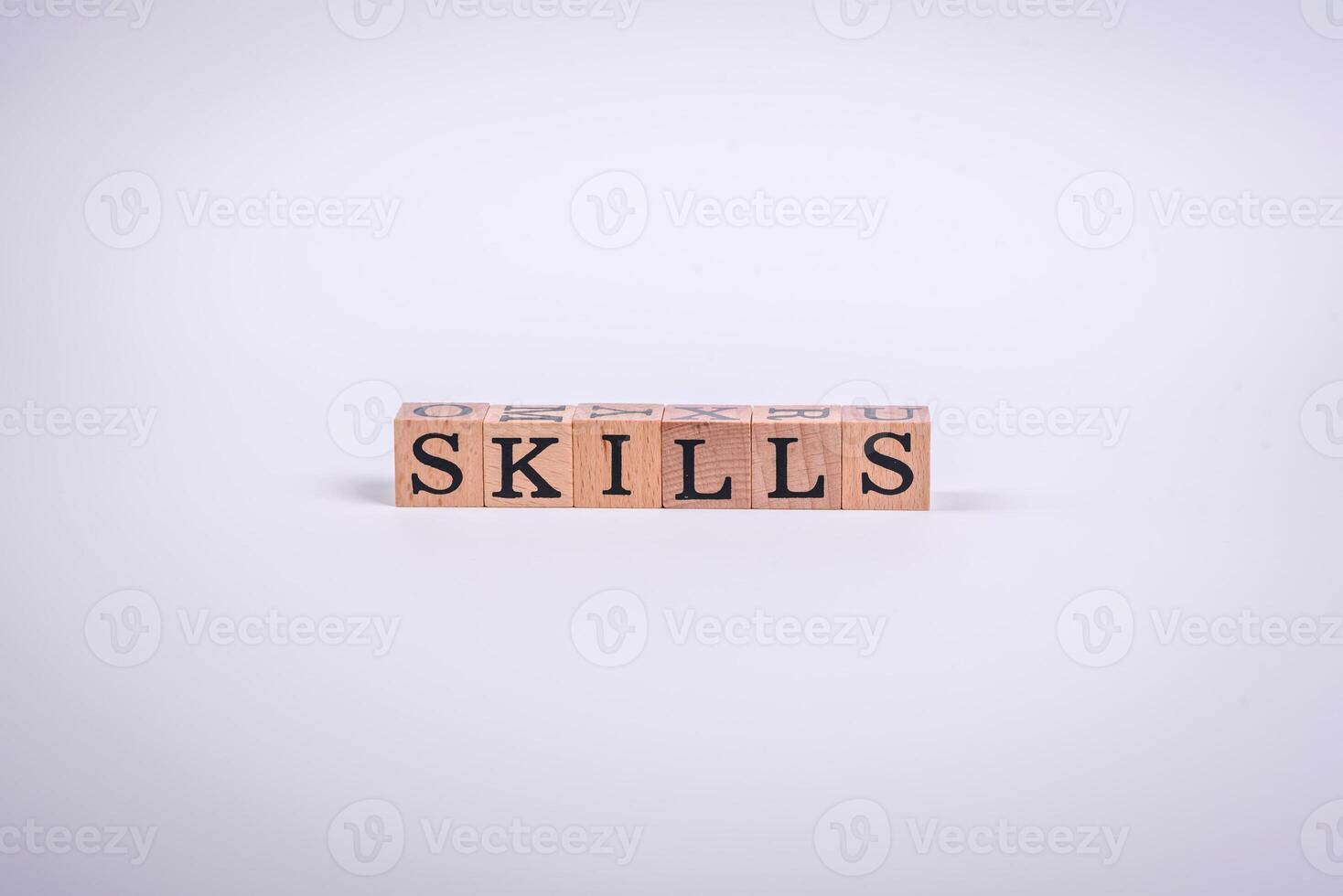 The inscription Skills made of wooden cubes on a plain background photo