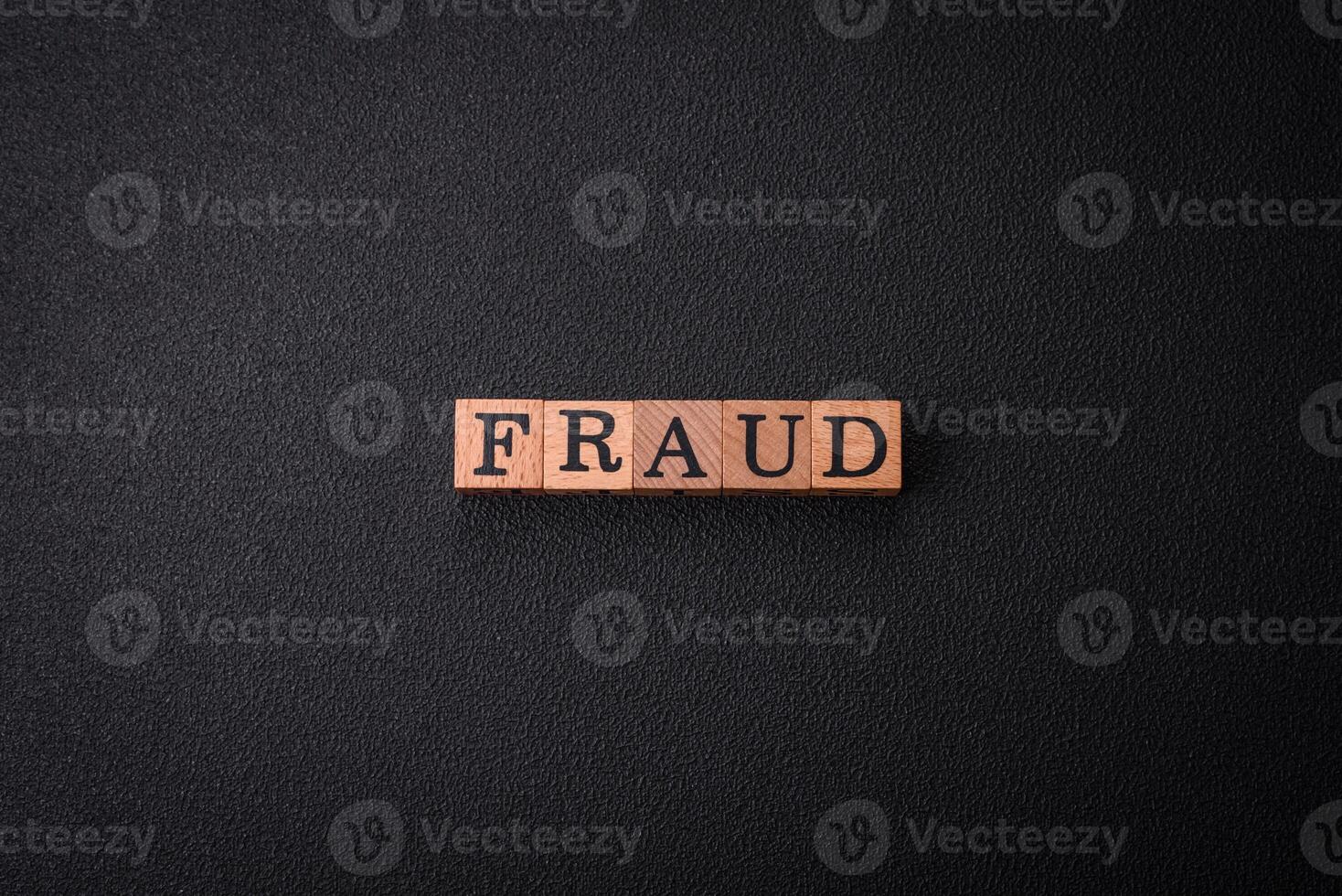 The inscription Fraud inspection made of wooden cubes on a plain background photo