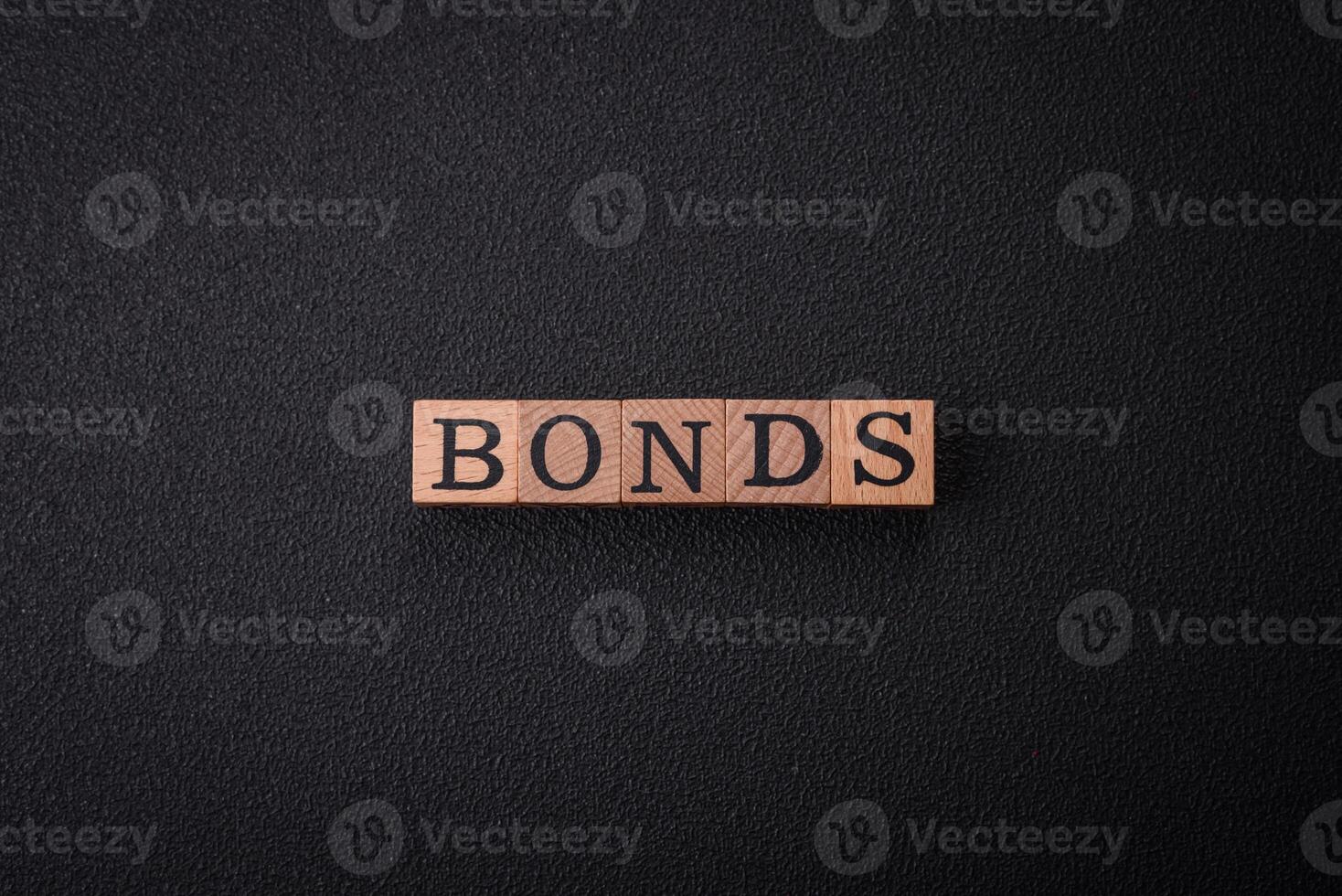 The inscription Bonds made of wooden cubes on a plain background photo
