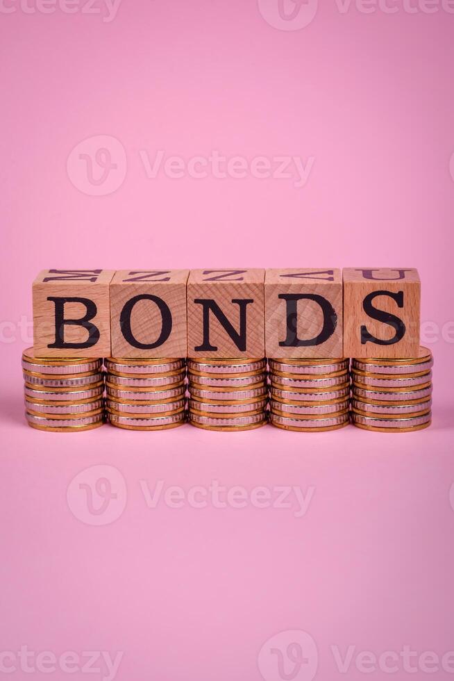 The inscription Bonds made of wooden cubes on a plain background photo