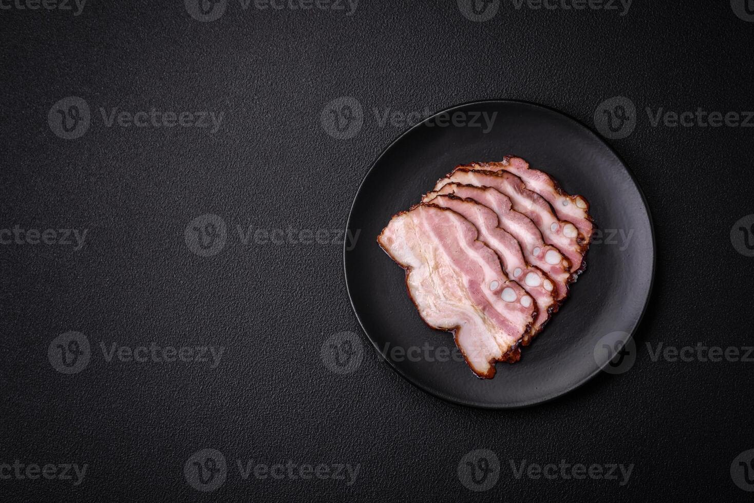 Delicious fresh pancetta or bacon with salt and spices cut into thin slices photo