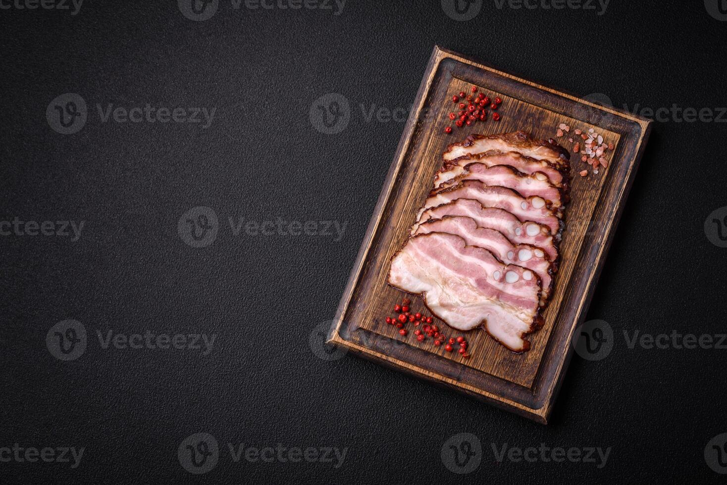 Delicious fresh pancetta or bacon with salt and spices cut into thin slices photo