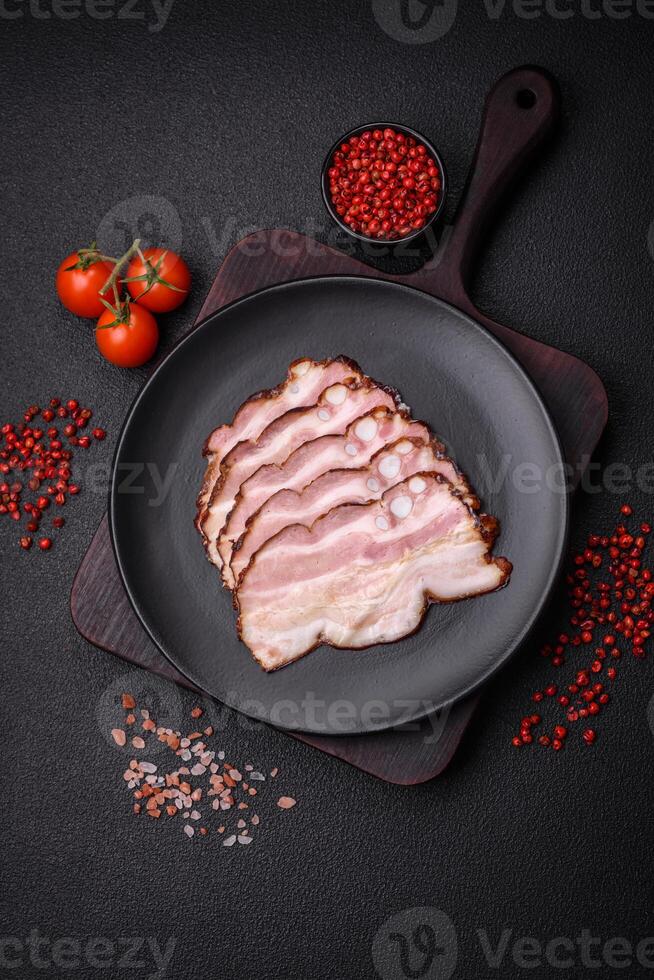 Delicious fresh pancetta or bacon with salt and spices cut into thin slices photo