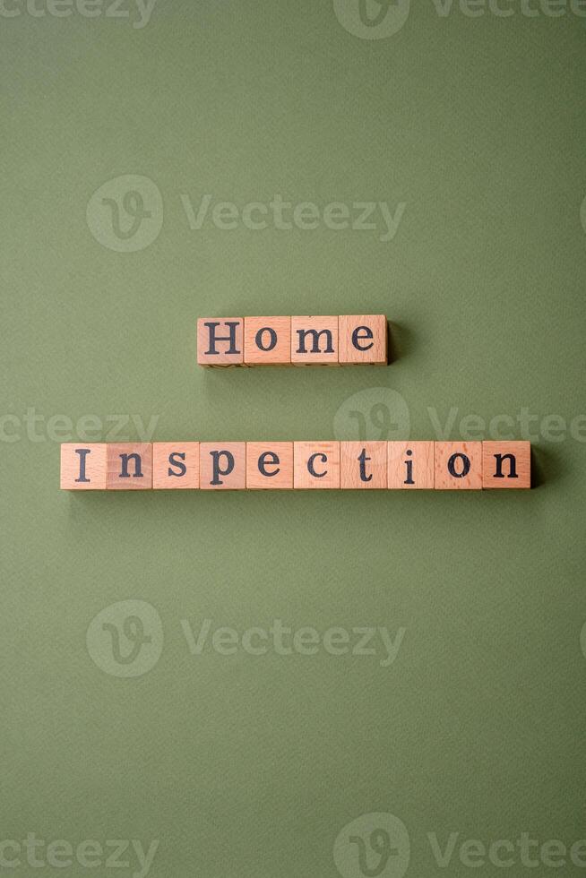 The inscription Home inspection made of wooden cubes on a plain background photo