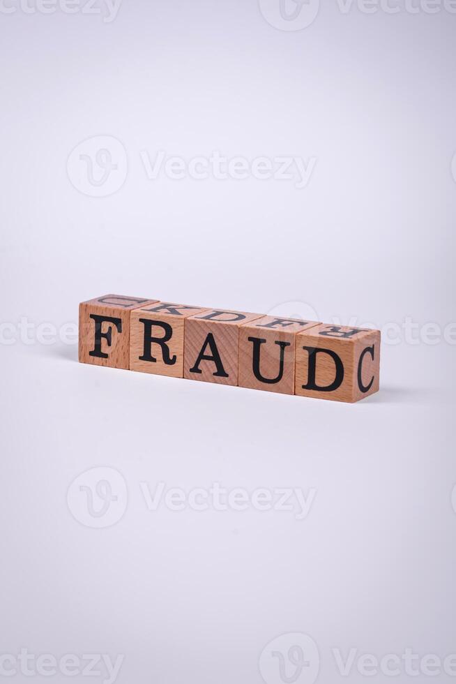 The inscription Fraud inspection made of wooden cubes on a plain background photo