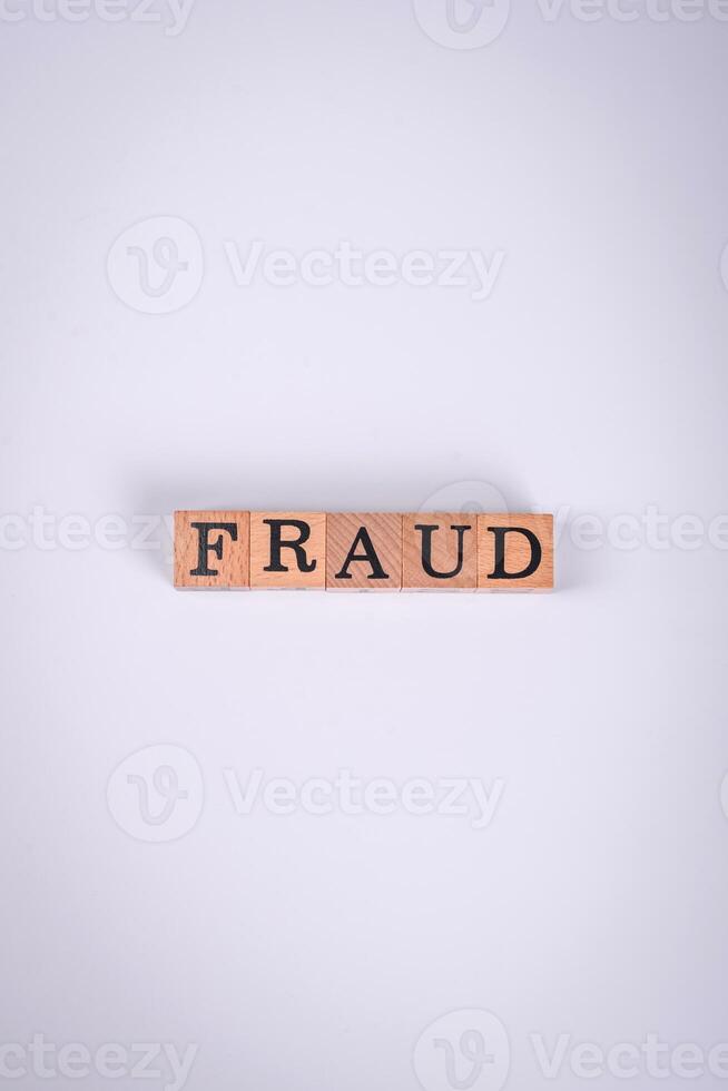 The inscription Fraud inspection made of wooden cubes on a plain background photo