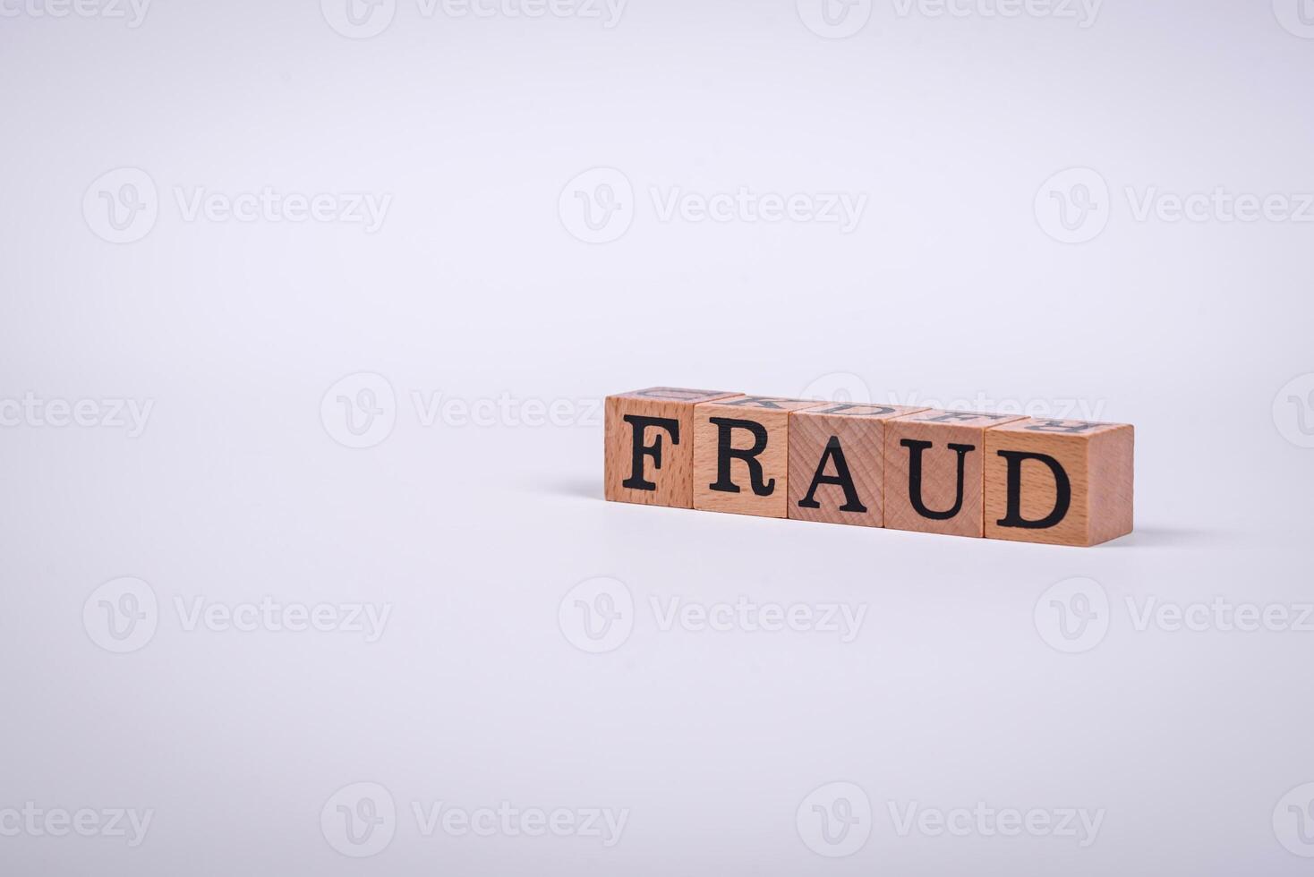 The inscription Fraud inspection made of wooden cubes on a plain background photo