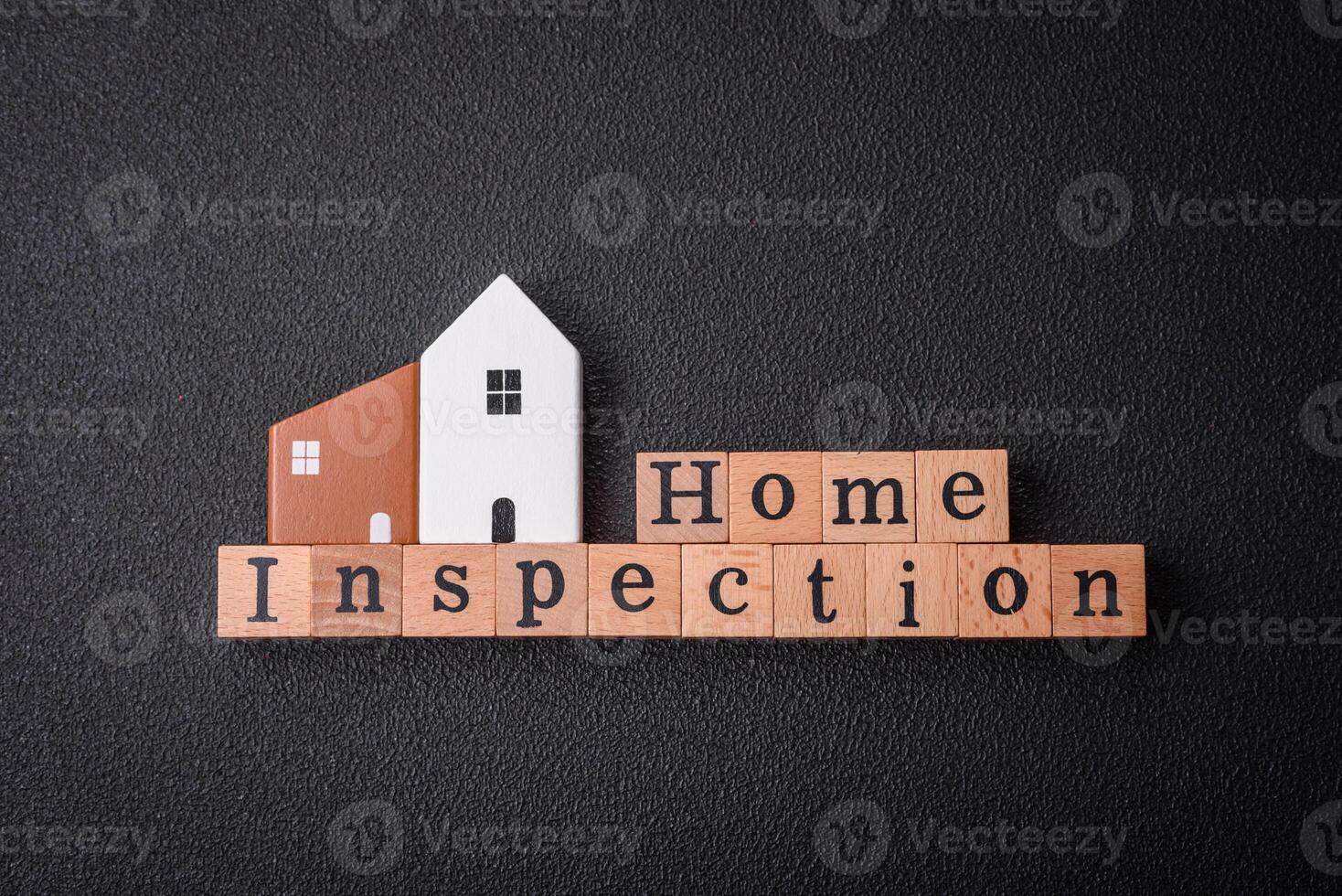 The inscription Home inspection made of wooden cubes on a plain background photo