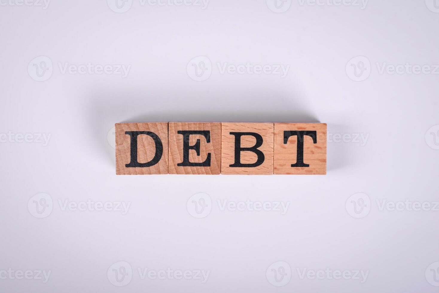 The inscription Debt inspection made of wooden cubes on a plain background photo