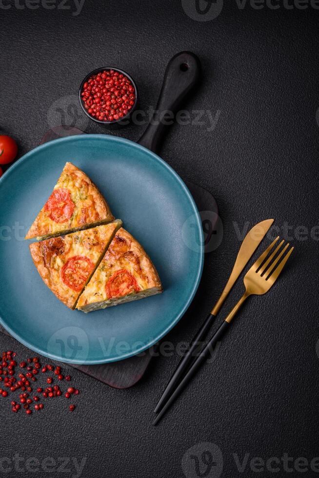 Delicious quiche with tomato, cheese, chicken, spices and herbs photo