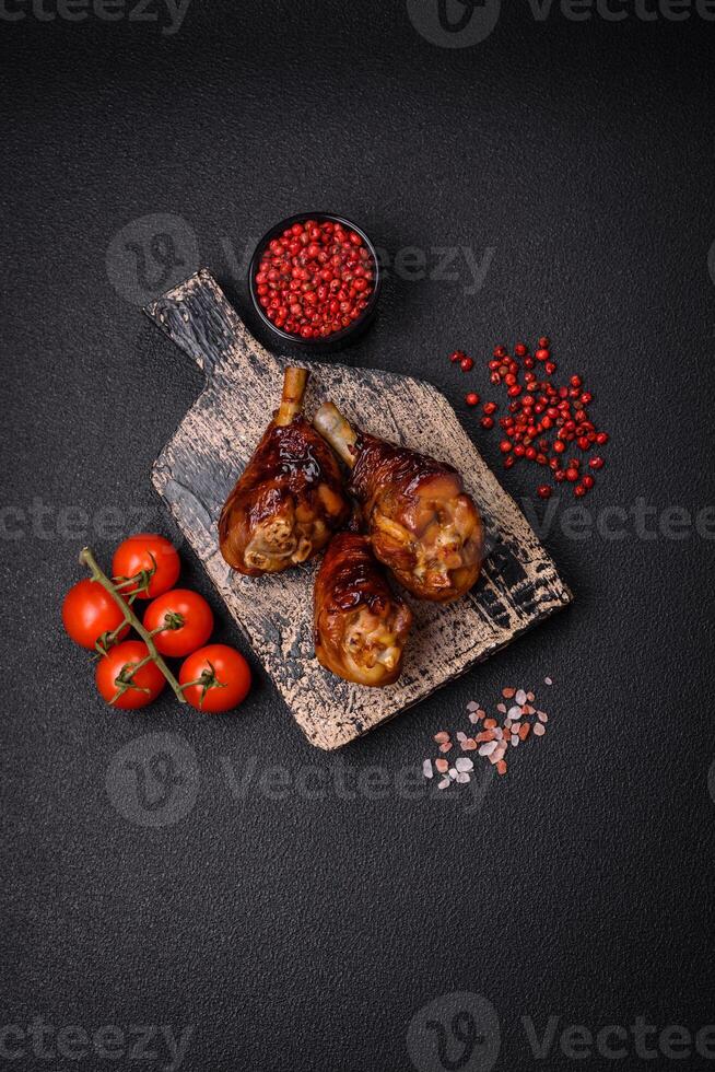 Delicious grilled chicken legs with spices and herbs in teriyaki sauce photo