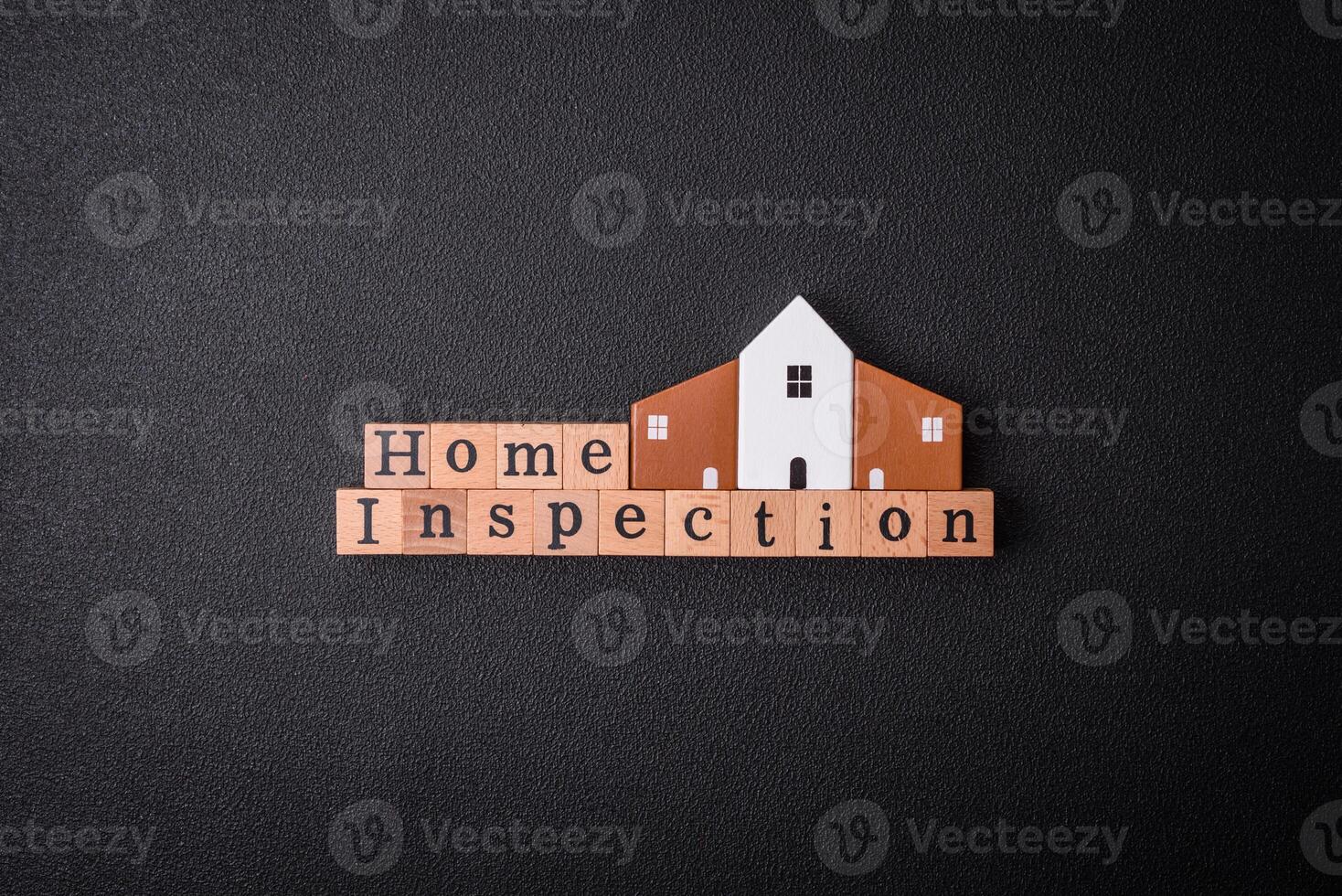 The inscription Home inspection made of wooden cubes on a plain background photo