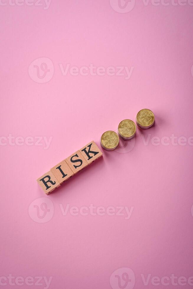 The inscription Risk made of wooden cubes on a plain background photo