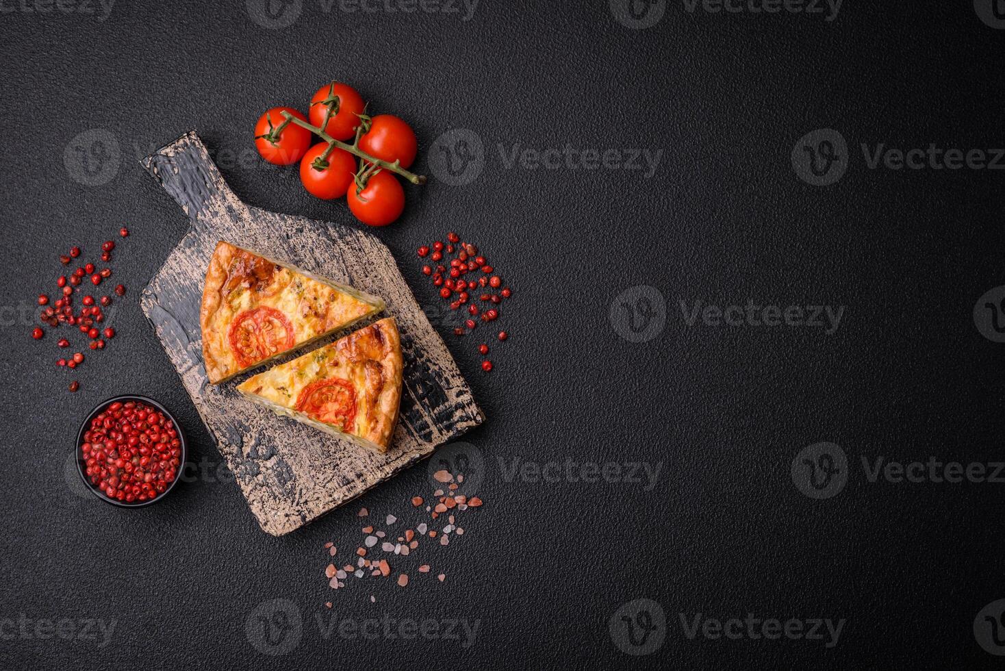Delicious quiche with tomato, cheese, chicken, spices and herbs photo