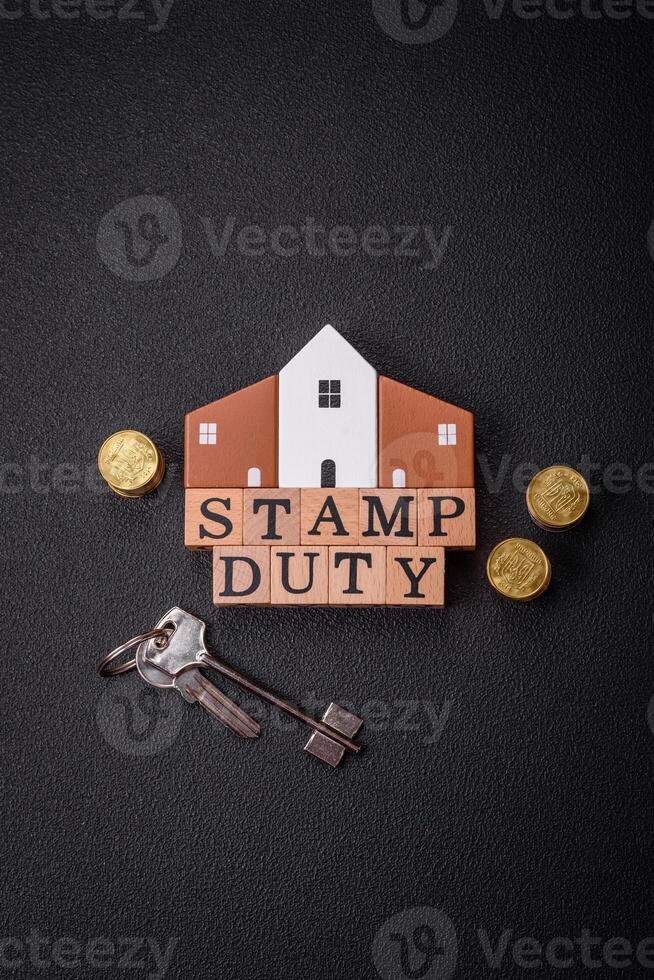 The inscription Stamp Duty made of wooden cubes on a plain background photo