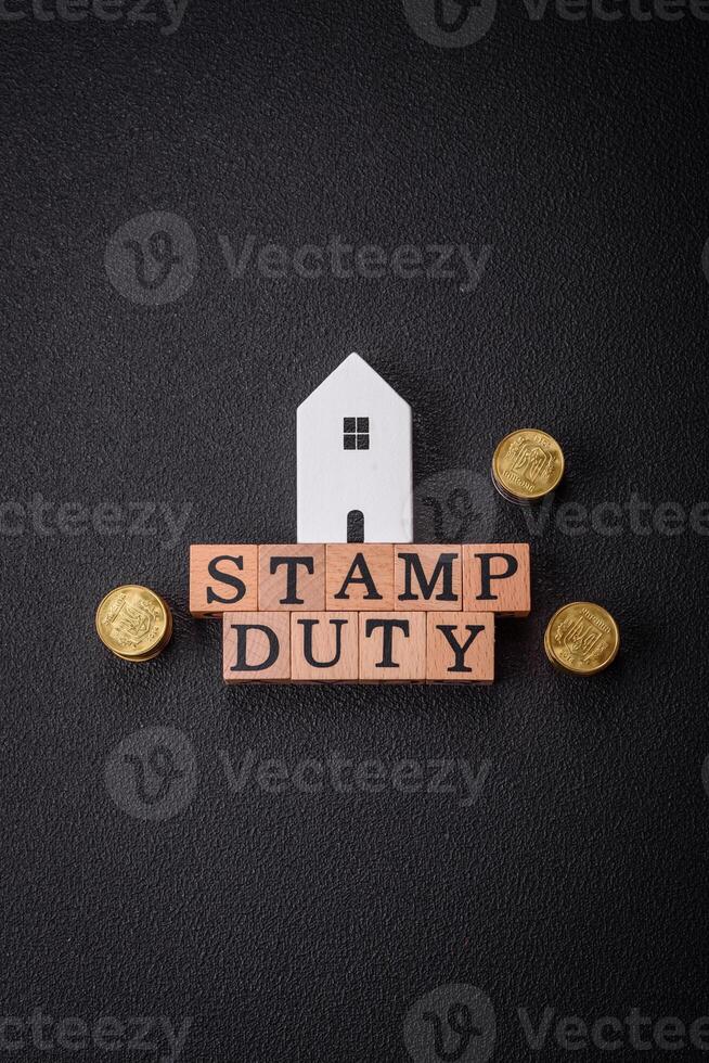 The inscription Stamp Duty made of wooden cubes on a plain background photo