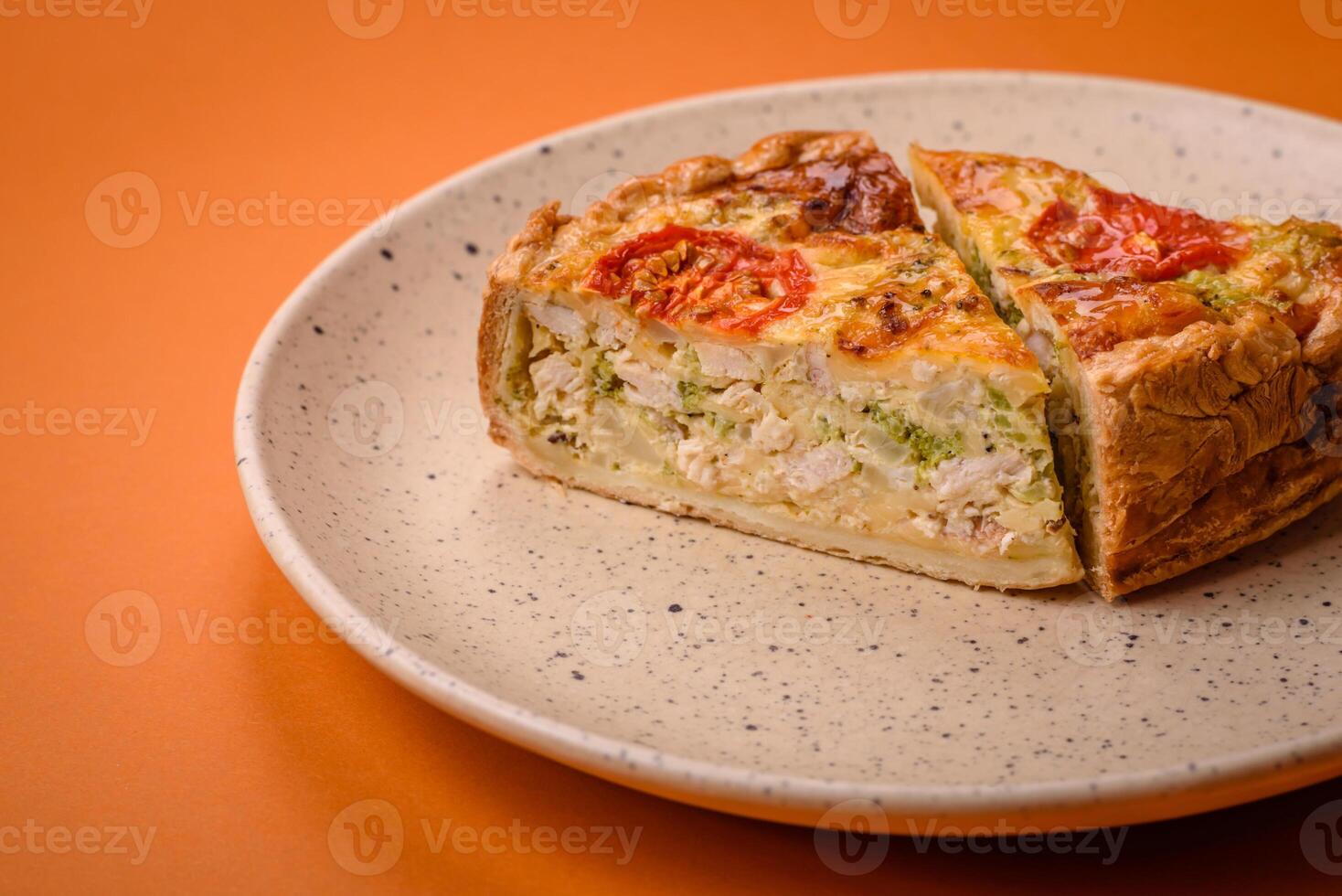 Delicious quiche with tomato, cheese, chicken, spices and herbs photo