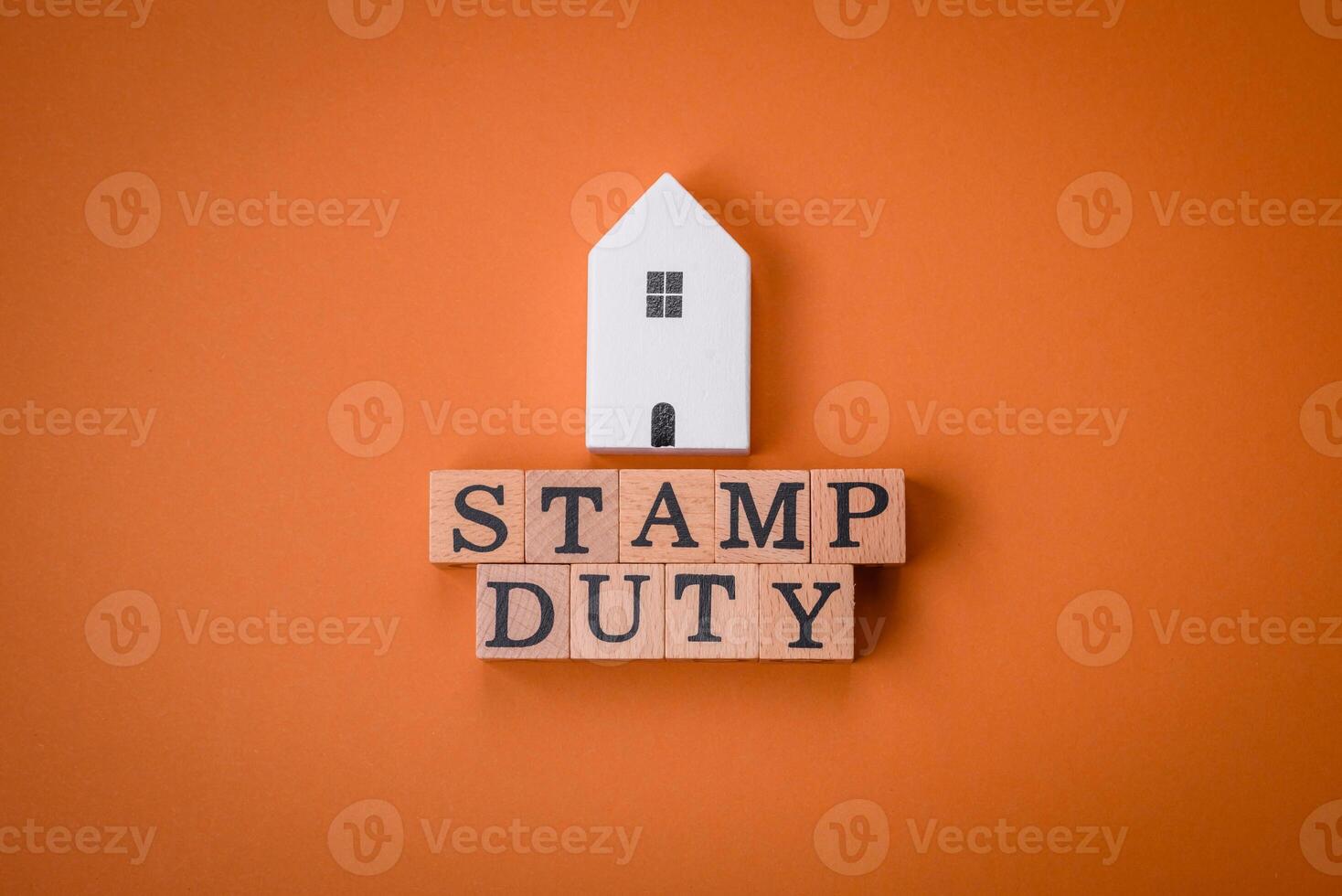 The inscription Stamp Duty made of wooden cubes on a plain background photo