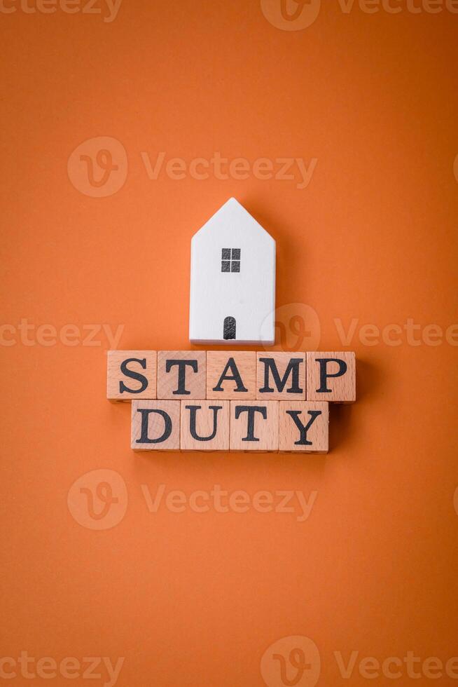 The inscription Stamp Duty made of wooden cubes on a plain background photo