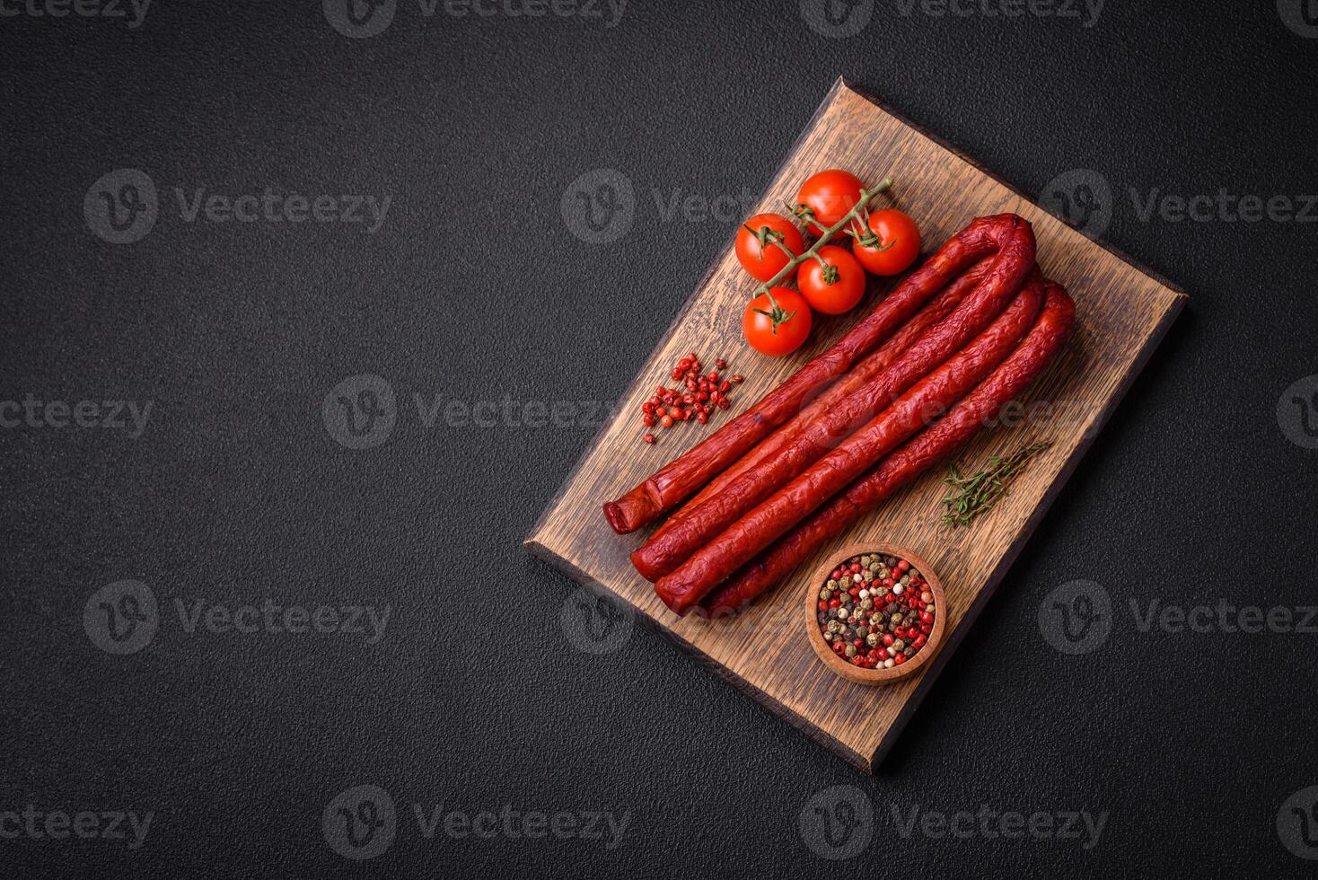 Delicious thin smoked hunting sausages with salt, spices and herbs photo