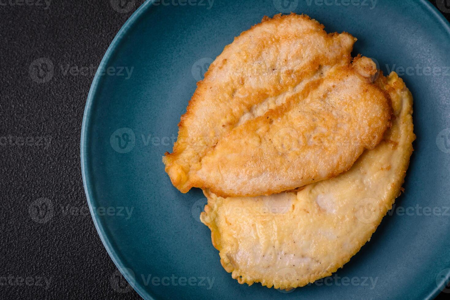 Delicious battered chicken breast chops with salt, spices and herbs photo
