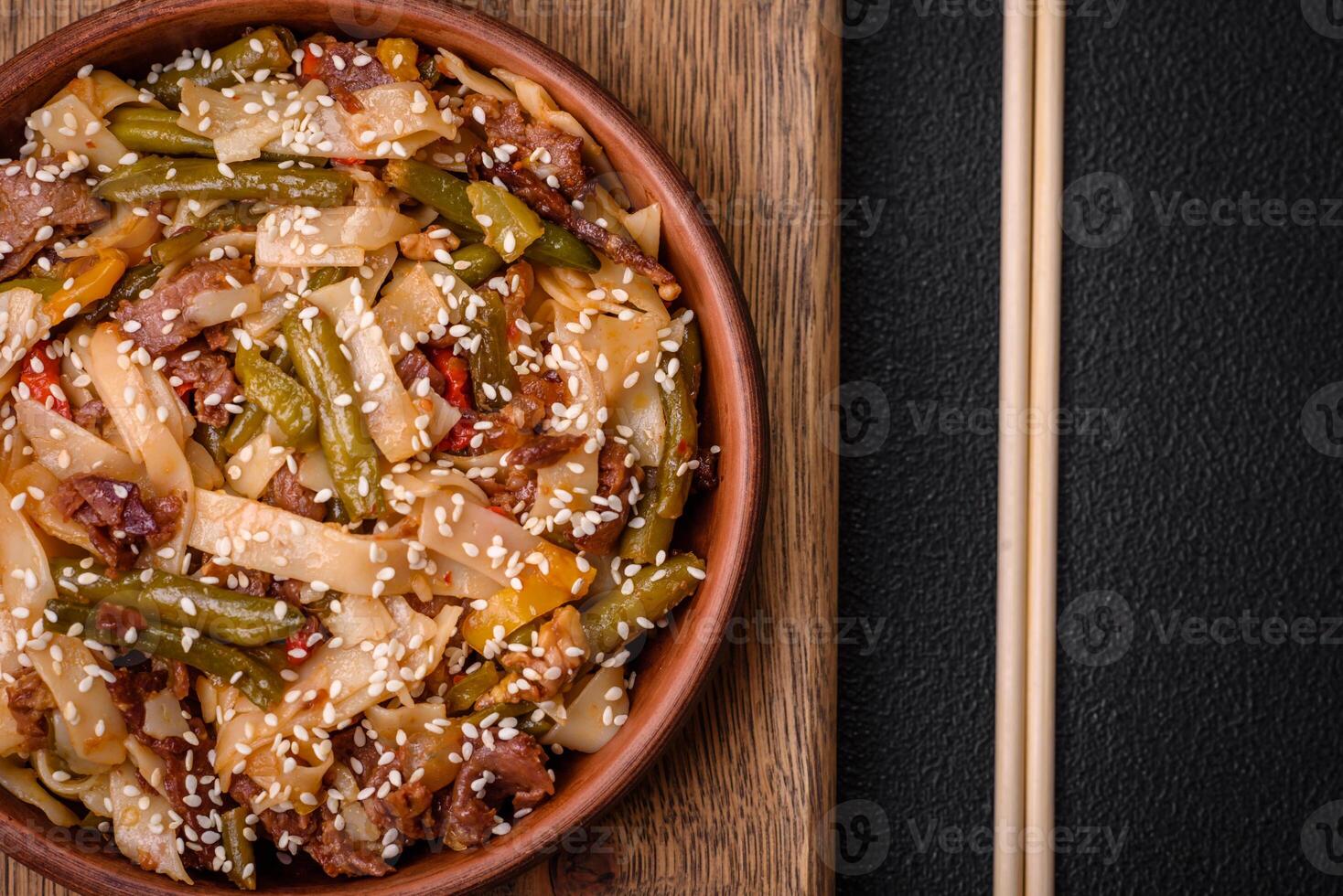 Delicious Asian dish udon with hot peppers, green beans, spices and herbs photo