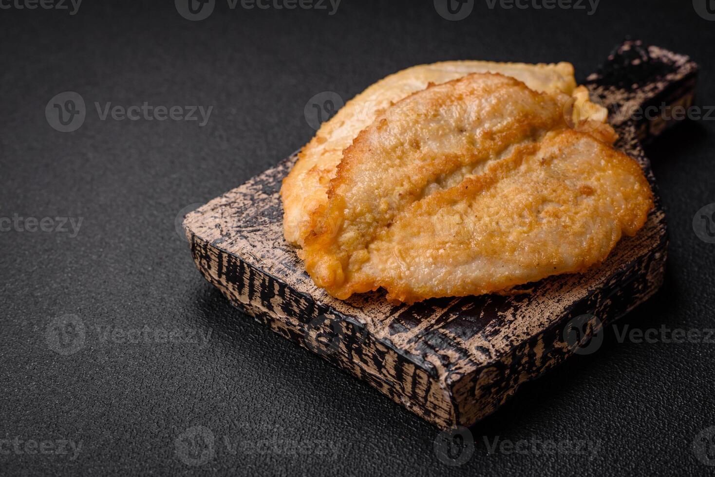 Delicious battered chicken breast chops with salt, spices and herbs photo