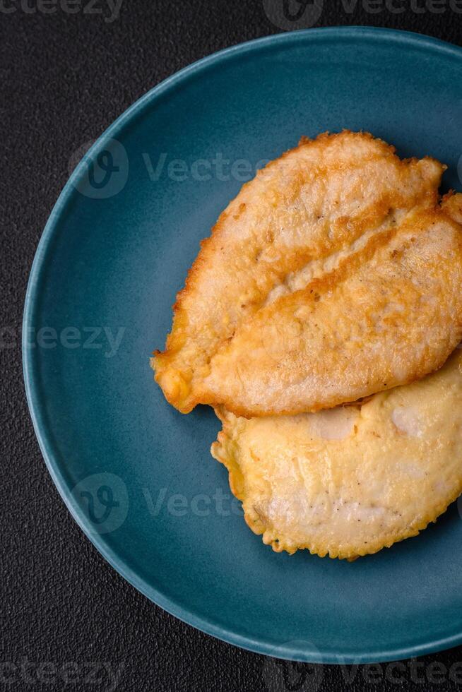 Delicious battered chicken breast chops with salt, spices and herbs photo