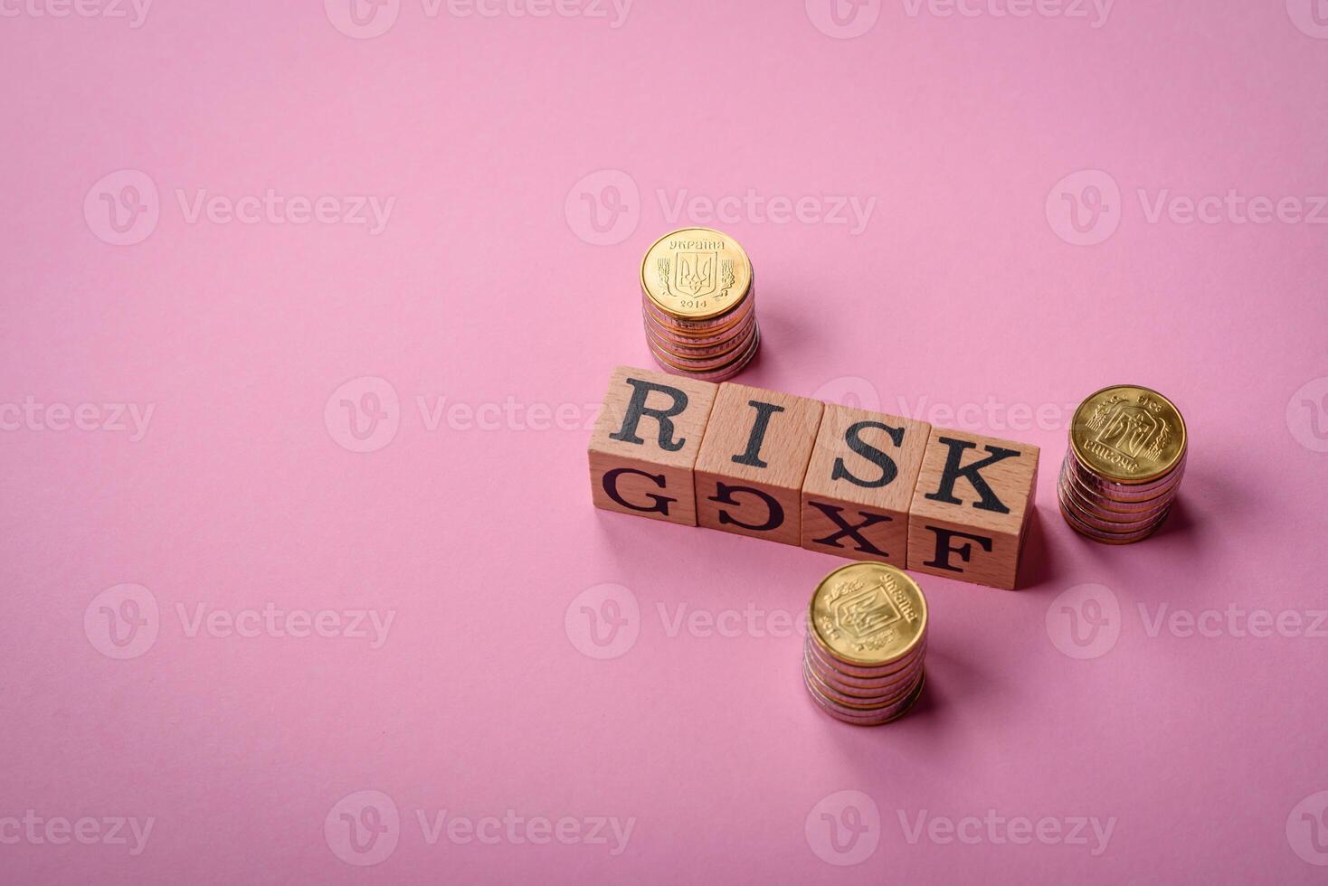 The inscription Risk made of wooden cubes on a plain background photo