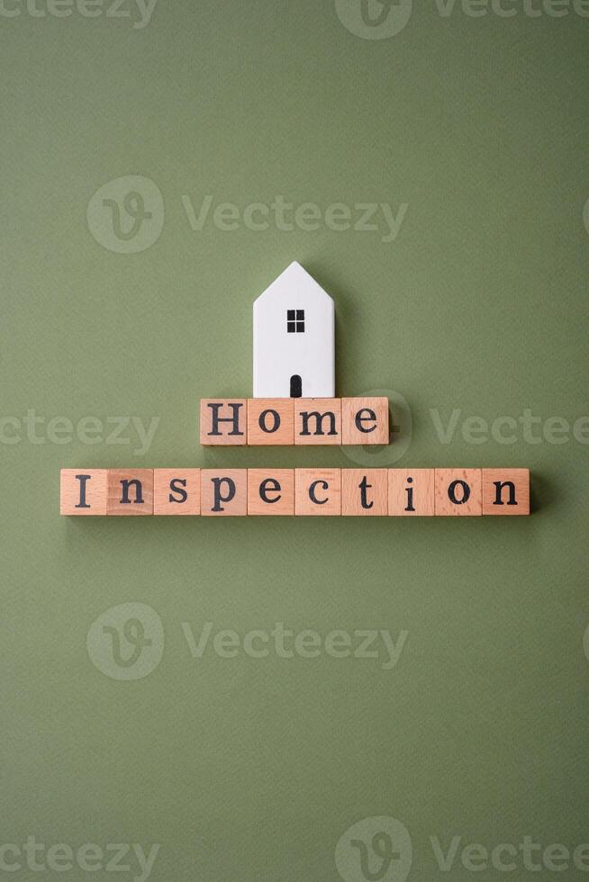 The inscription Home inspection made of wooden cubes on a plain background photo