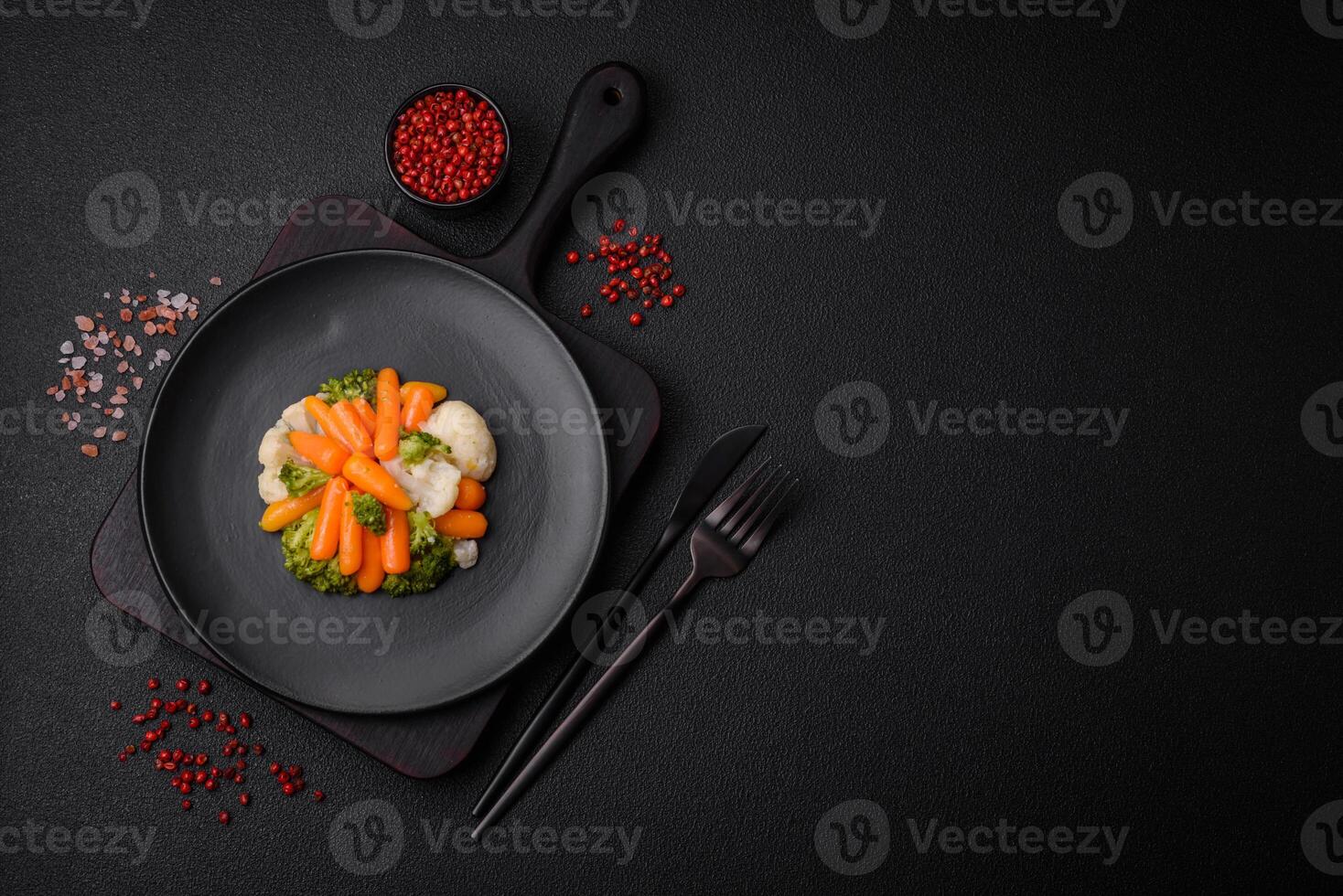 Delicious fresh vegetables broccoli, cauliflower, carrots steamed with salt and spices photo