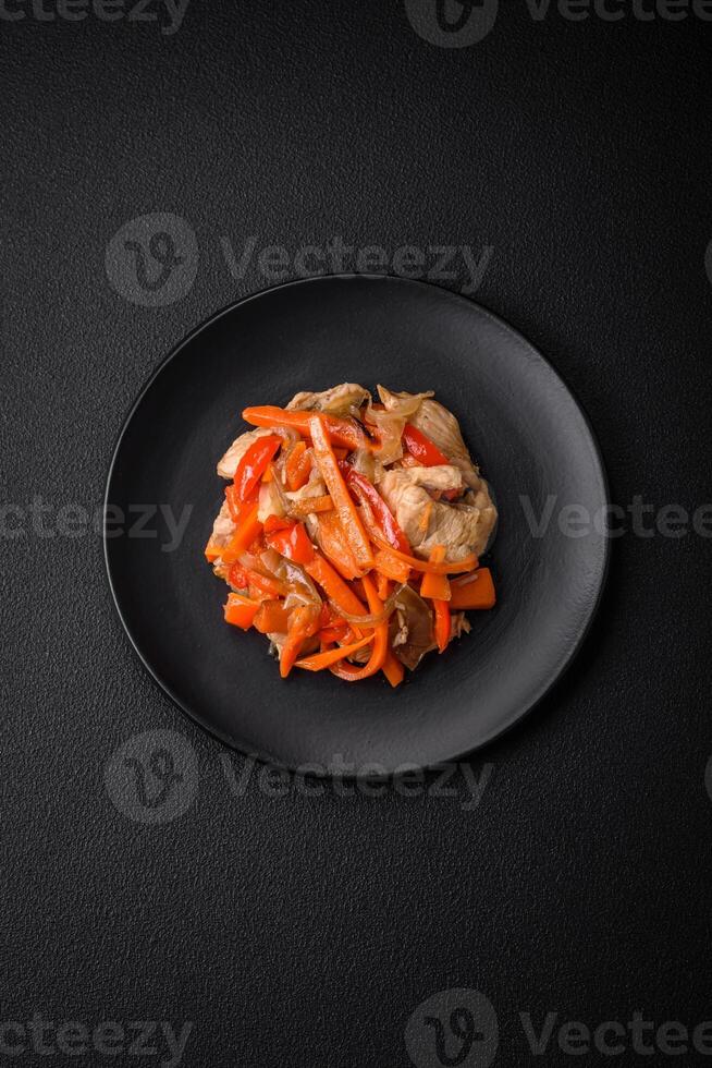 Delicious fresh stew with chicken or turkey with slices of sweet pepper and carrots photo