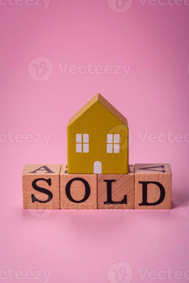 A small wooden house and the inscription sold. Concept for sale, rental of real estate for a family photo