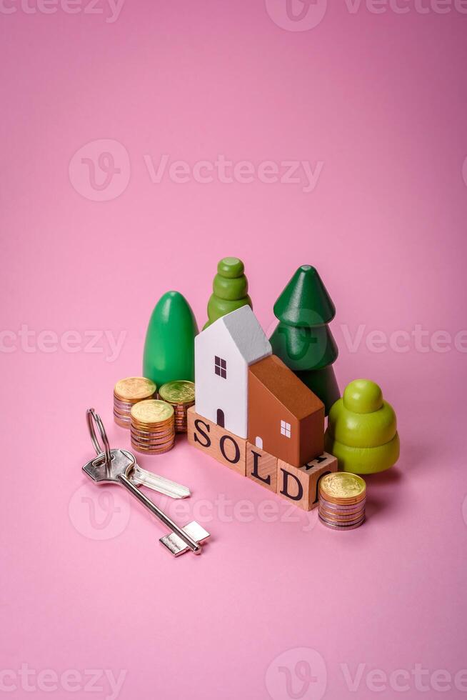 A small wooden house and the inscription sold. Concept for sale, rental of real estate for a family photo