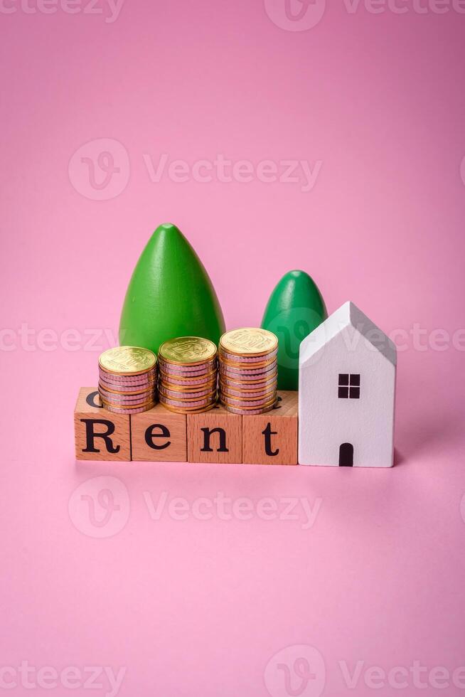 Small wooden house and the inscription for rent. Concept for sale, rental of real estate for a family photo