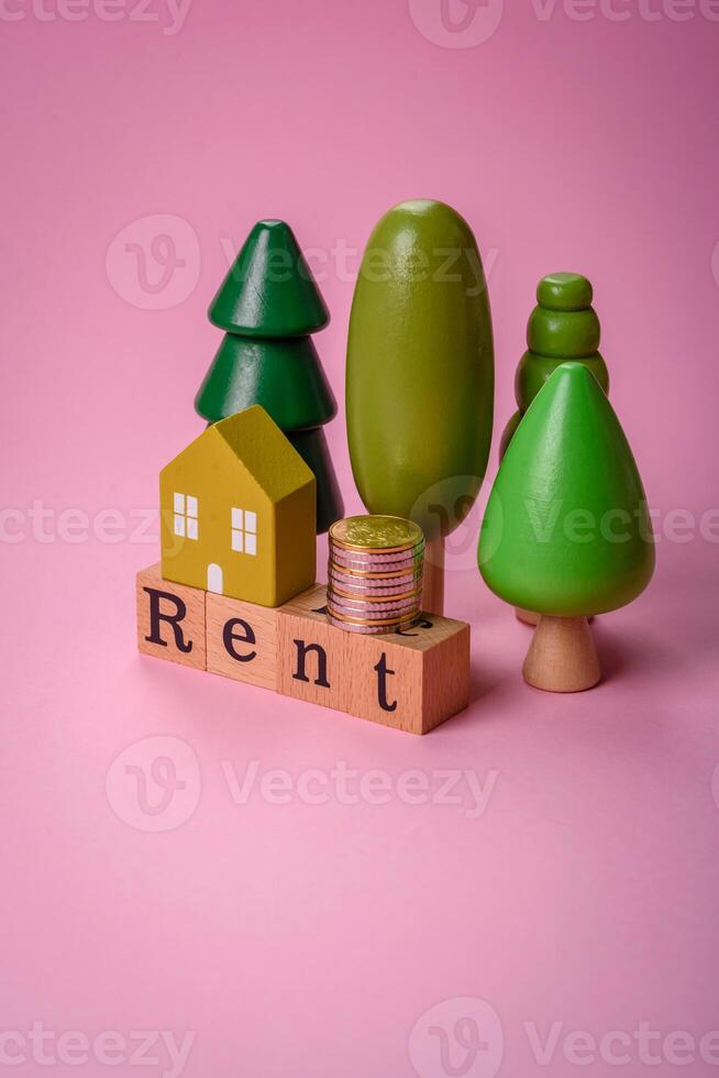 Small wooden house and the inscription for rent. Concept for sale, rental of real estate for a family photo