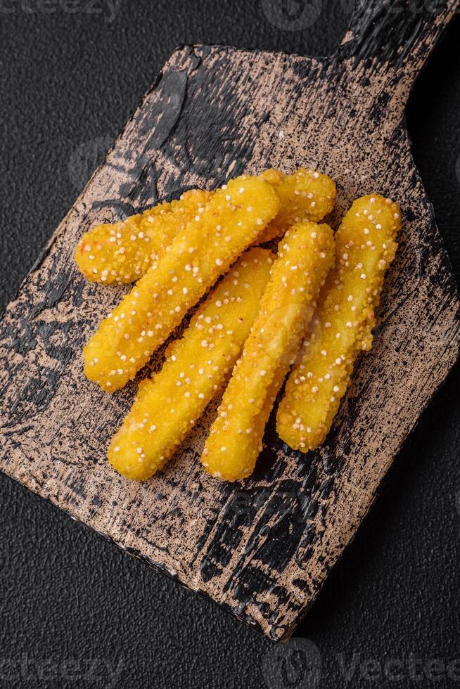 Delicious crispy cheese sticks with mozzarella, salt and spices, breaded and fried in oil photo