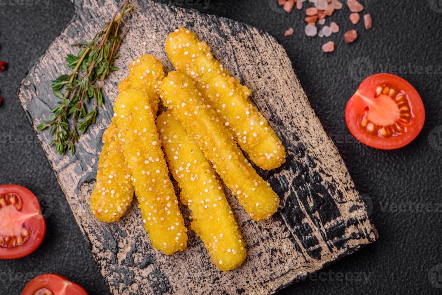 Delicious crispy cheese sticks with mozzarella, salt and spices, breaded and fried in oil photo