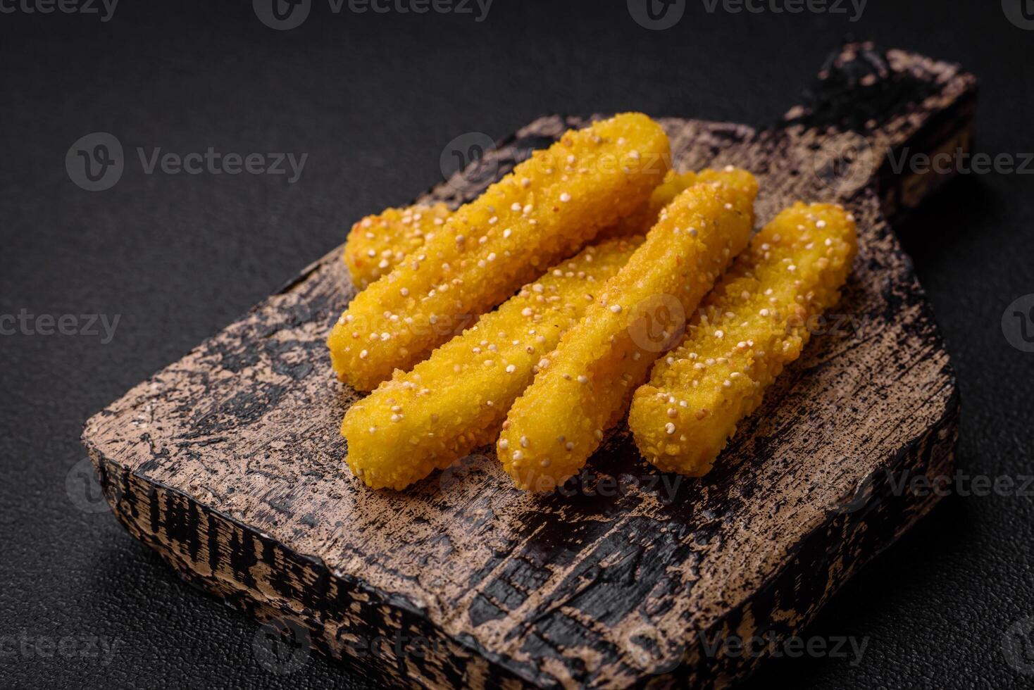 Delicious crispy cheese sticks with mozzarella, salt and spices, breaded and fried in oil photo