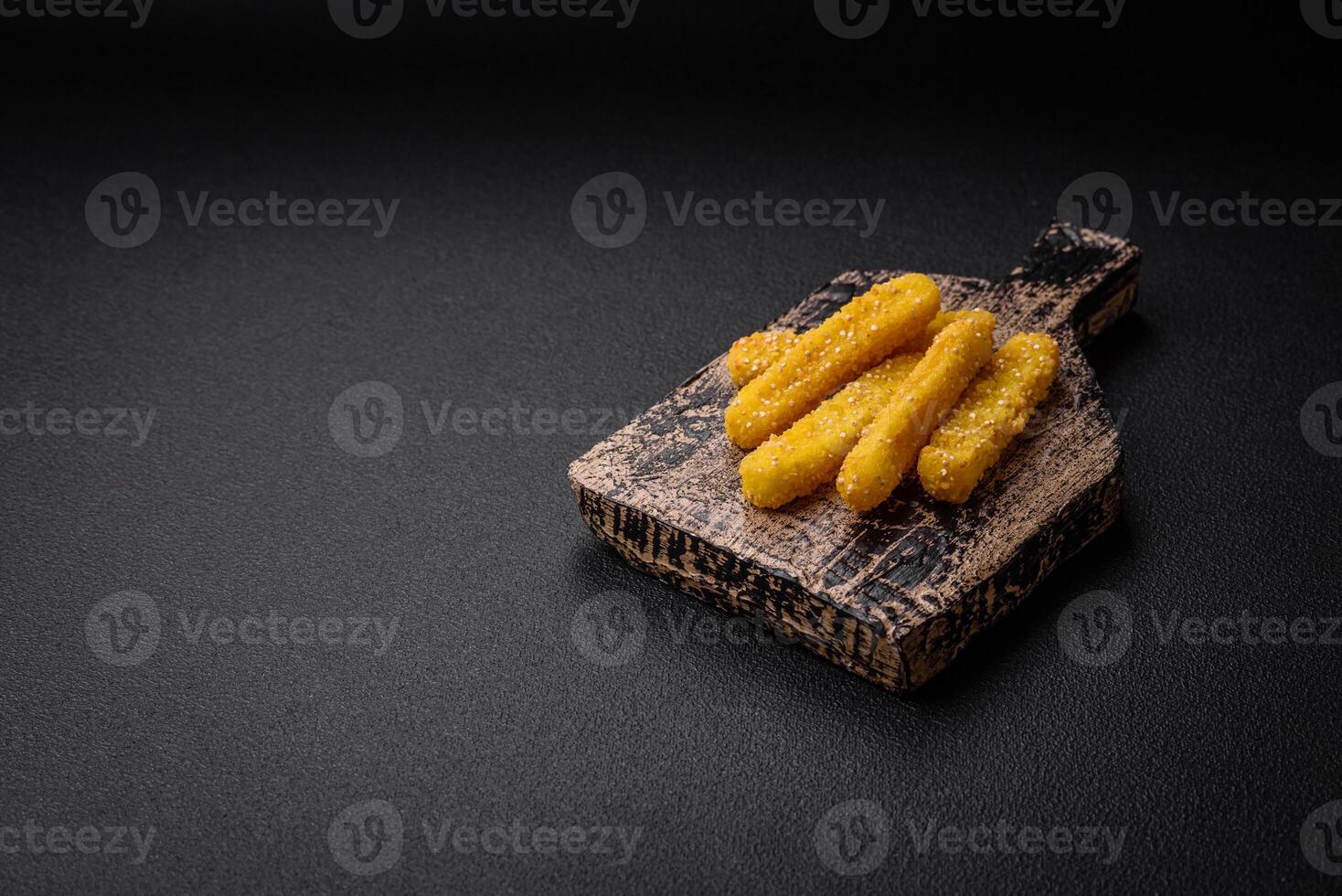Delicious crispy cheese sticks with mozzarella, salt and spices, breaded and fried in oil photo