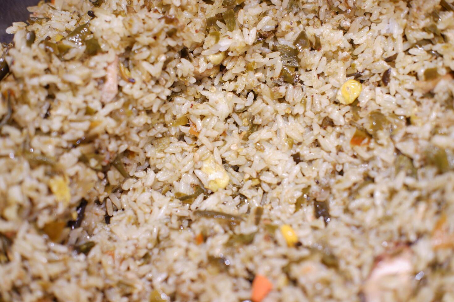 Delicious rice pilaf with broccoli in wok on wooden table photo