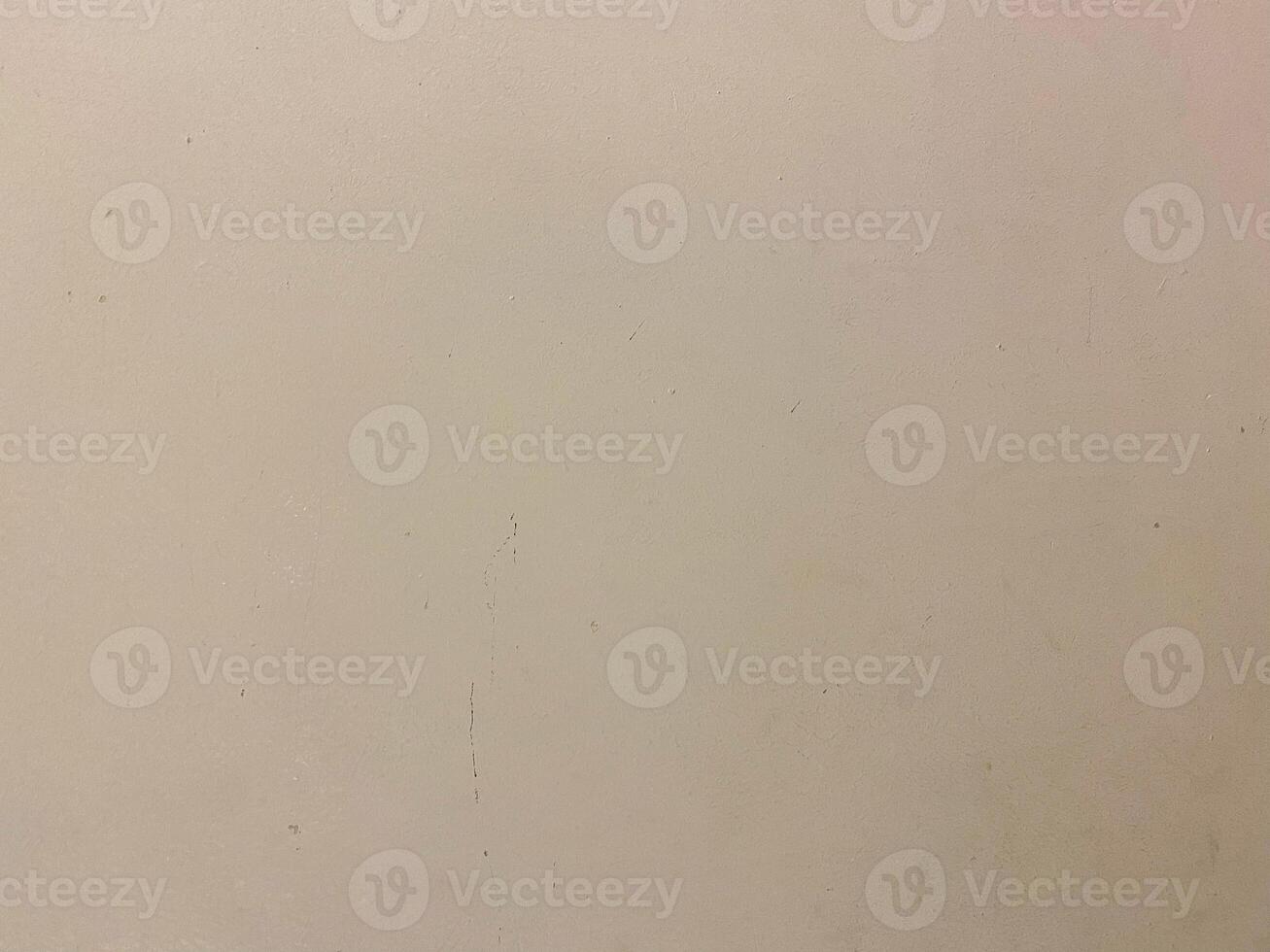 Old paint on a concrete wall, creating a textured and artistic white background. photo