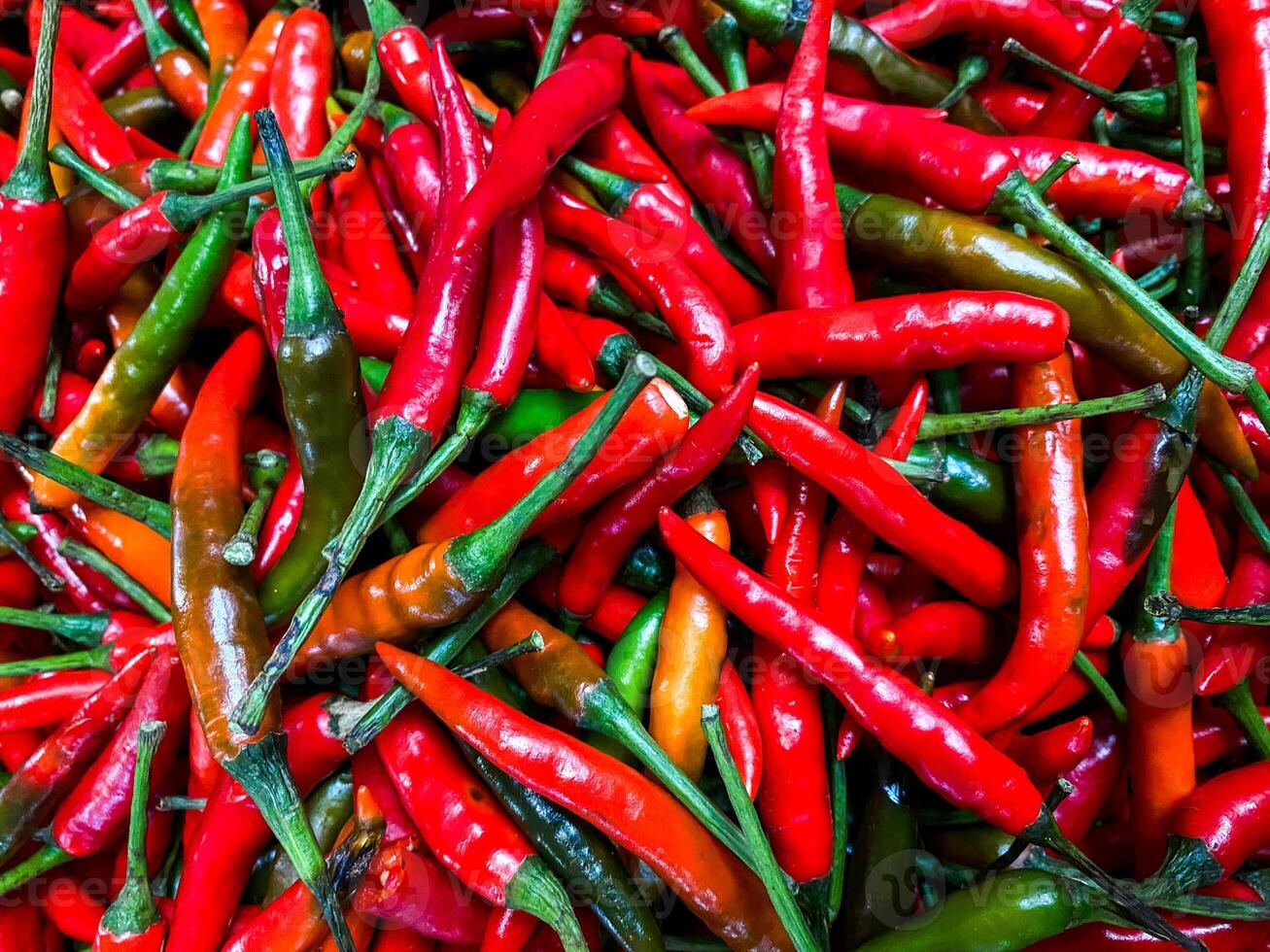 Red hot chilli peppers texture background. Close up view with copy space for design photo