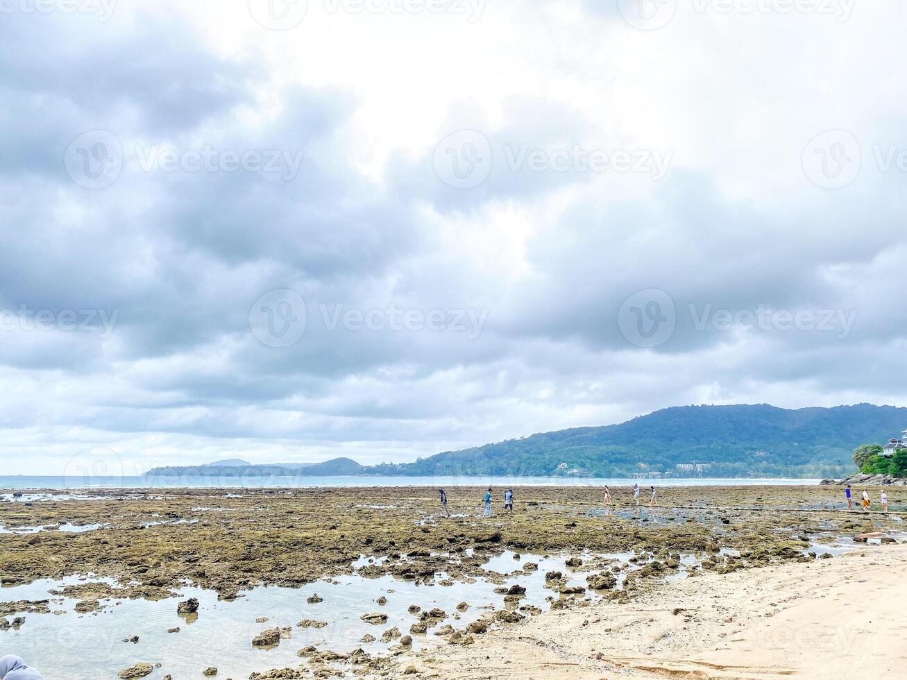 The landscape of Kamala Beach is a perfect blend of lush greenery, sandy shores, and the vibrant blue expanse of the Andaman Sea. photo