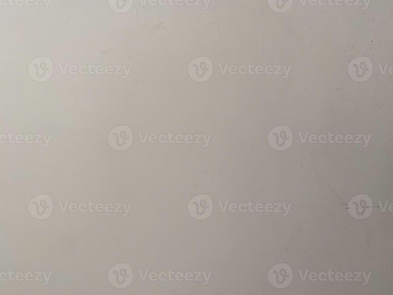 Old paint on a concrete wall, creating a textured and artistic white background. photo