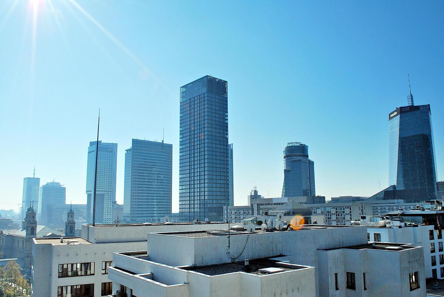 Glass building with transparent facade of the building and blue sky. Structural glass wall reflecting blue sky. Abstract modern architecture fragment. Contemporary architectural background. photo