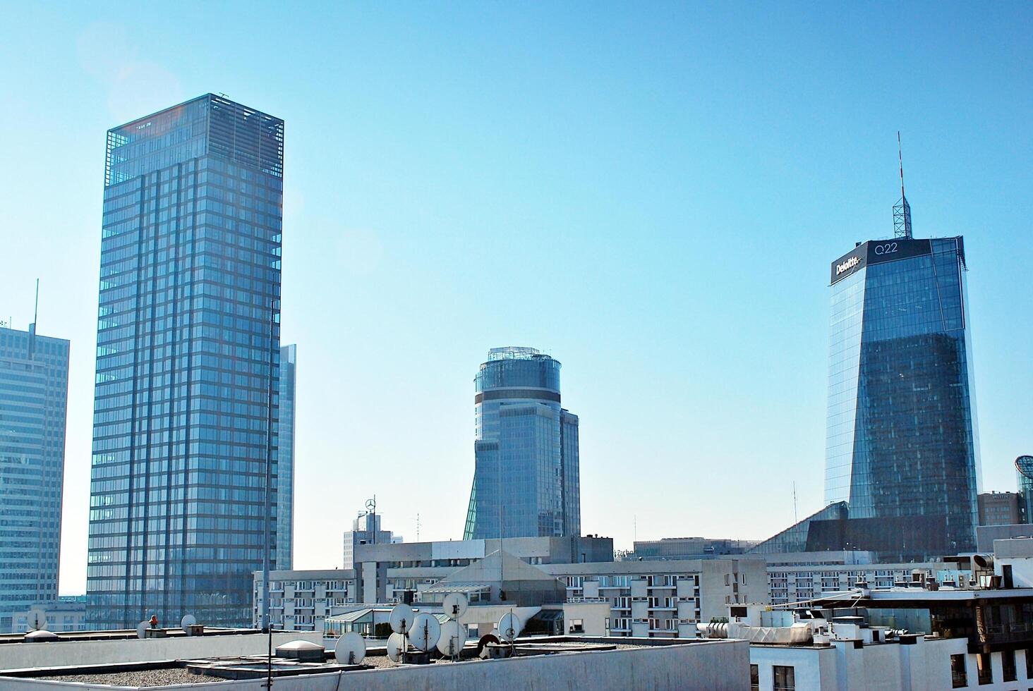 Glass building with transparent facade of the building and blue sky. Structural glass wall reflecting blue sky. Abstract modern architecture fragment. Contemporary architectural background. photo