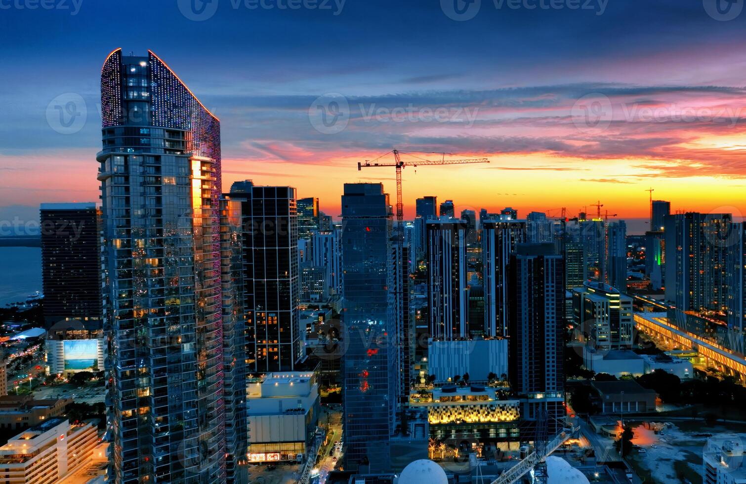 Aerial View of Miami City at Night From Building Top. An amazing aerial perspective of Miamis bustling cityscape at night, captured from the top of a building. photo