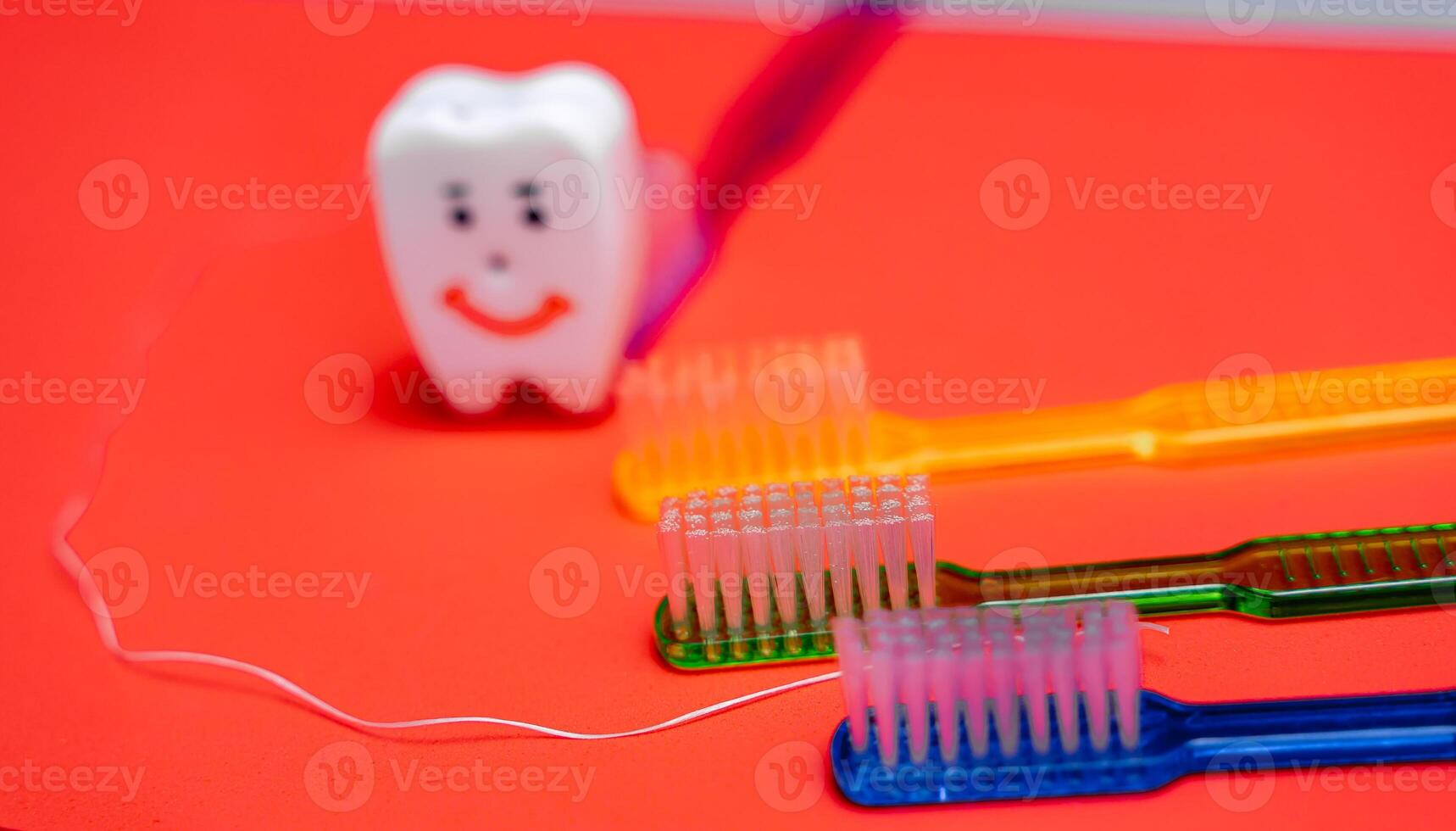 A Toothbrush, Toothpaste, and Toothpaste Tube on a Red photo